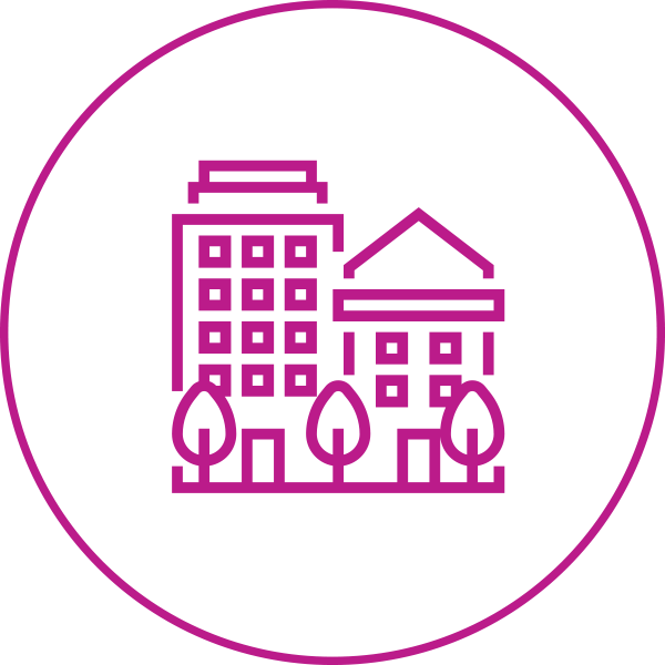 A round icon with a number of housing style structures such as a house and an apartment building.