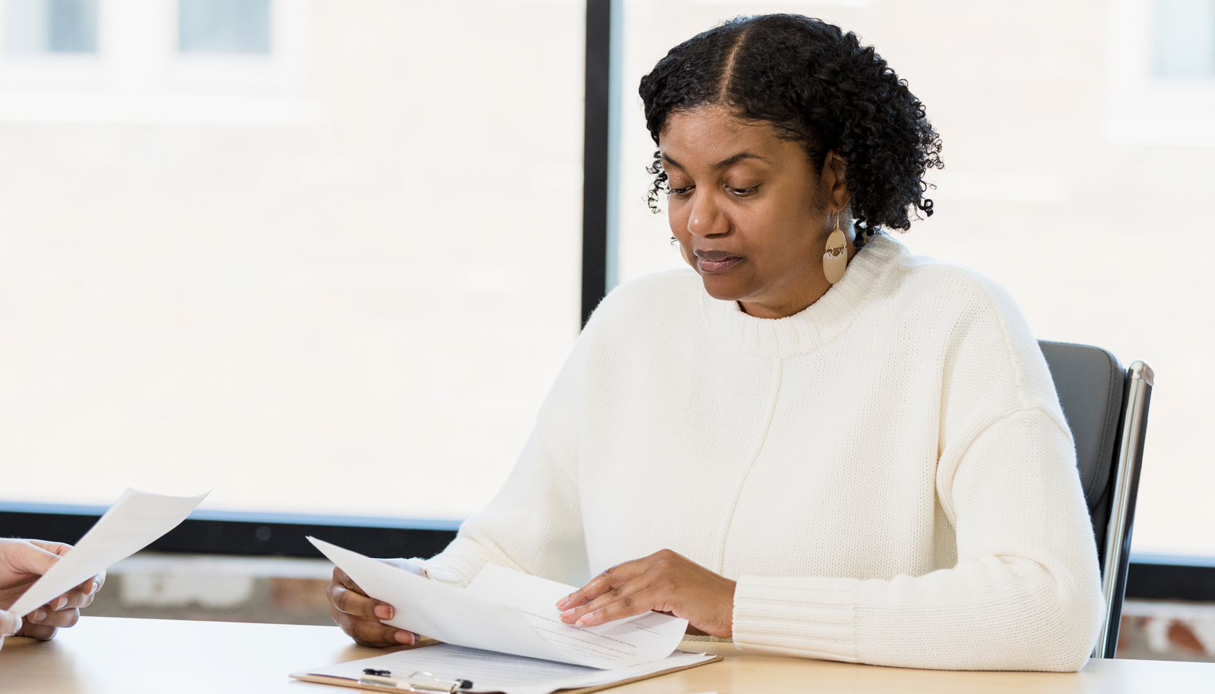 A photo of a black woman who appears to be in a leadership role.