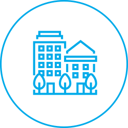 A round icon with a circle with a series of small buildings to indicate housing.